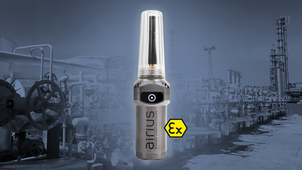An Airius sensor and an Ex logo overlaid on a background showing an industrial outdoor environment