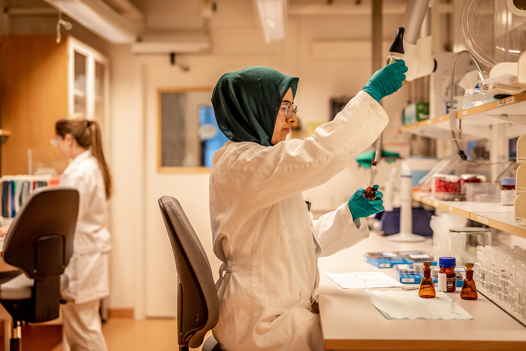 A person working at a table in a pharmaceutical lab