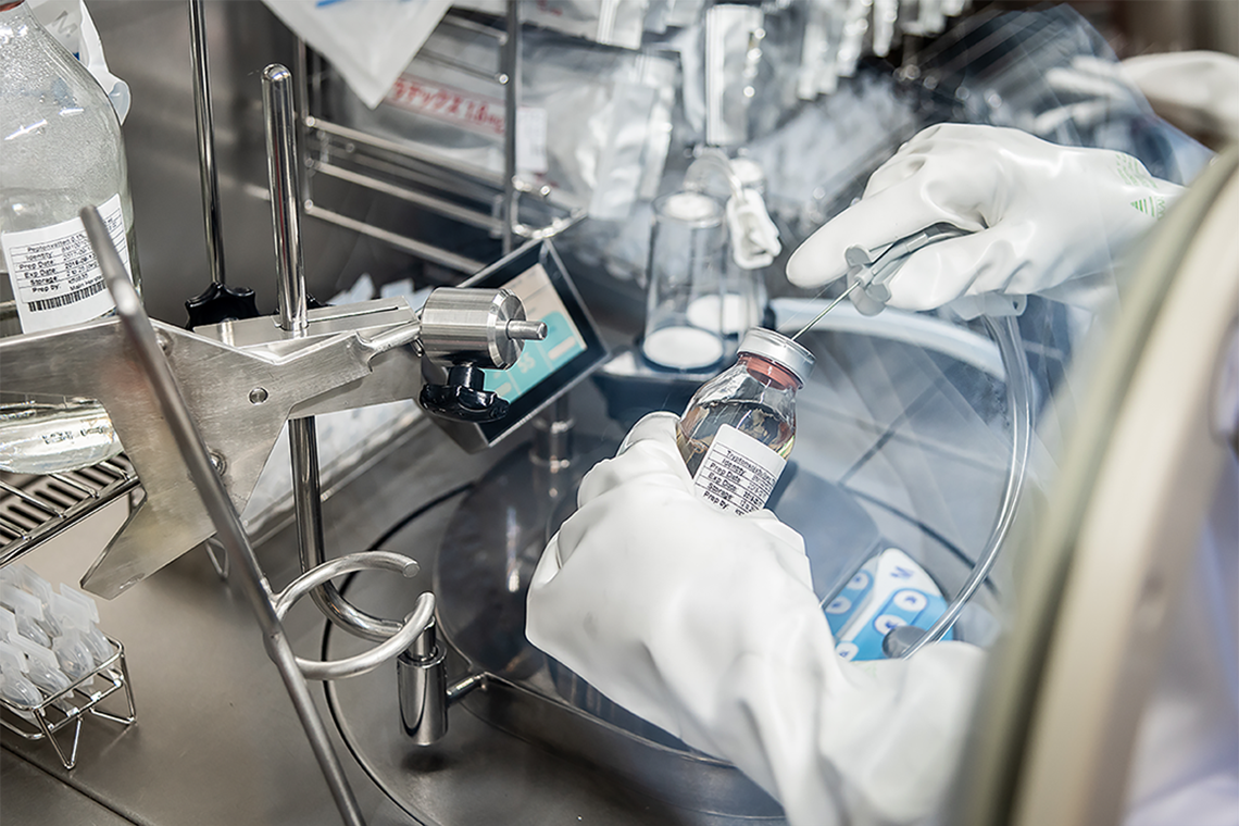 Gloved hands working in laboratory environment