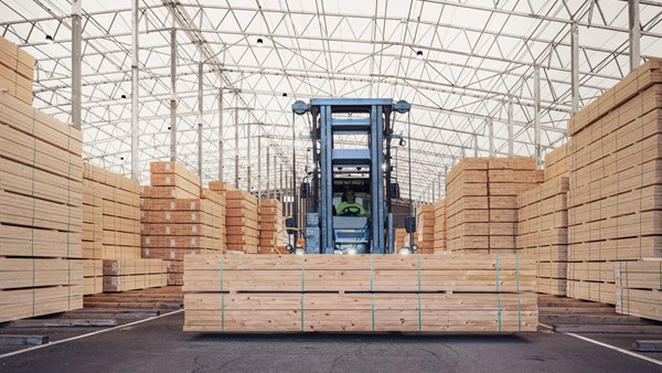 Stacks of timber in indoor storage, ready for loading