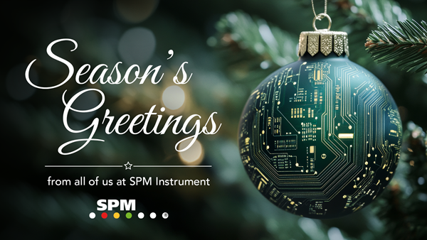 Christmas card with a green bauble with a circuit board pattern hanging from a spruce branch