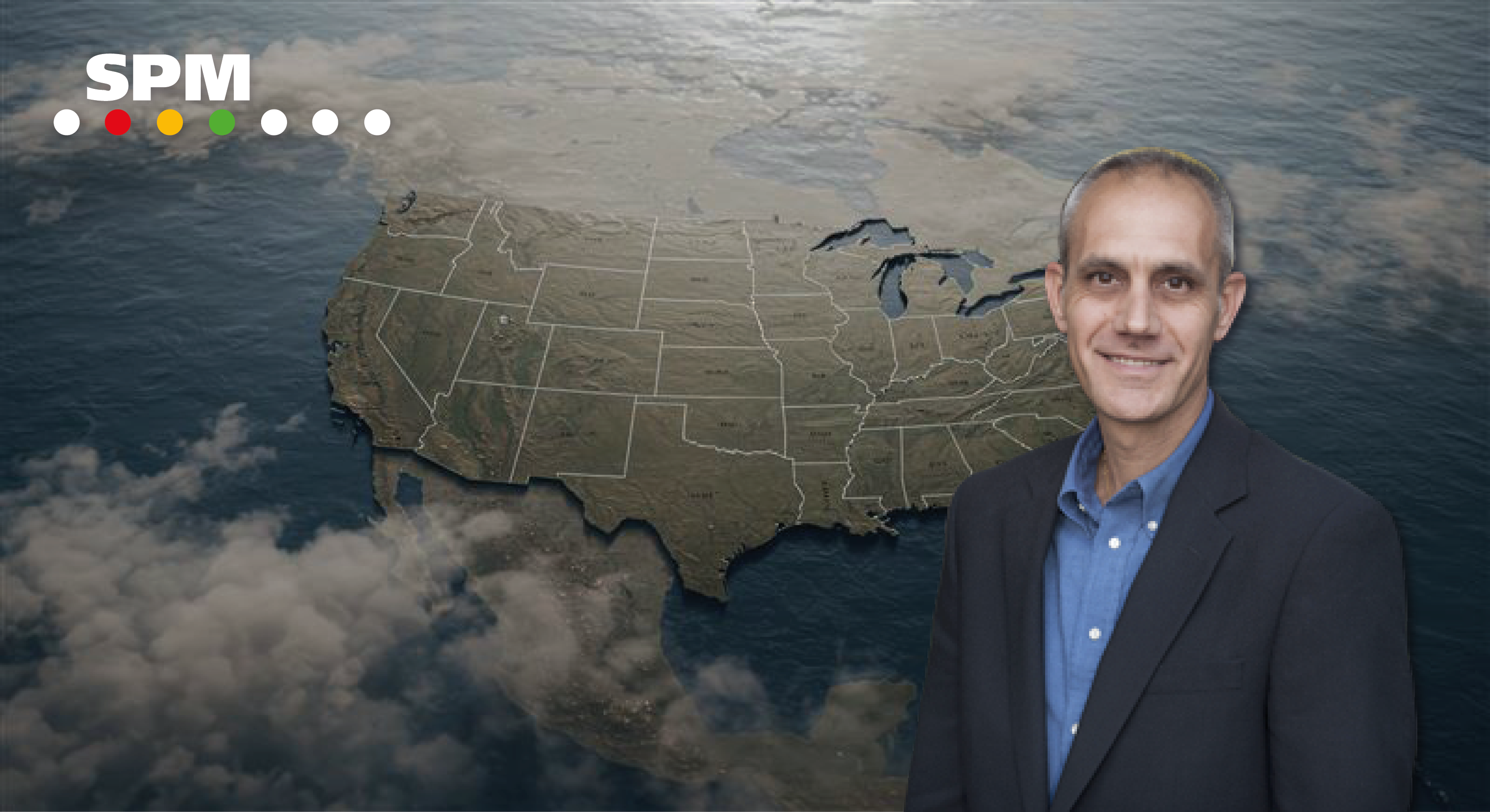 Upper body shot of a man in a blue shirt and jacket superimposed on a map of North America.